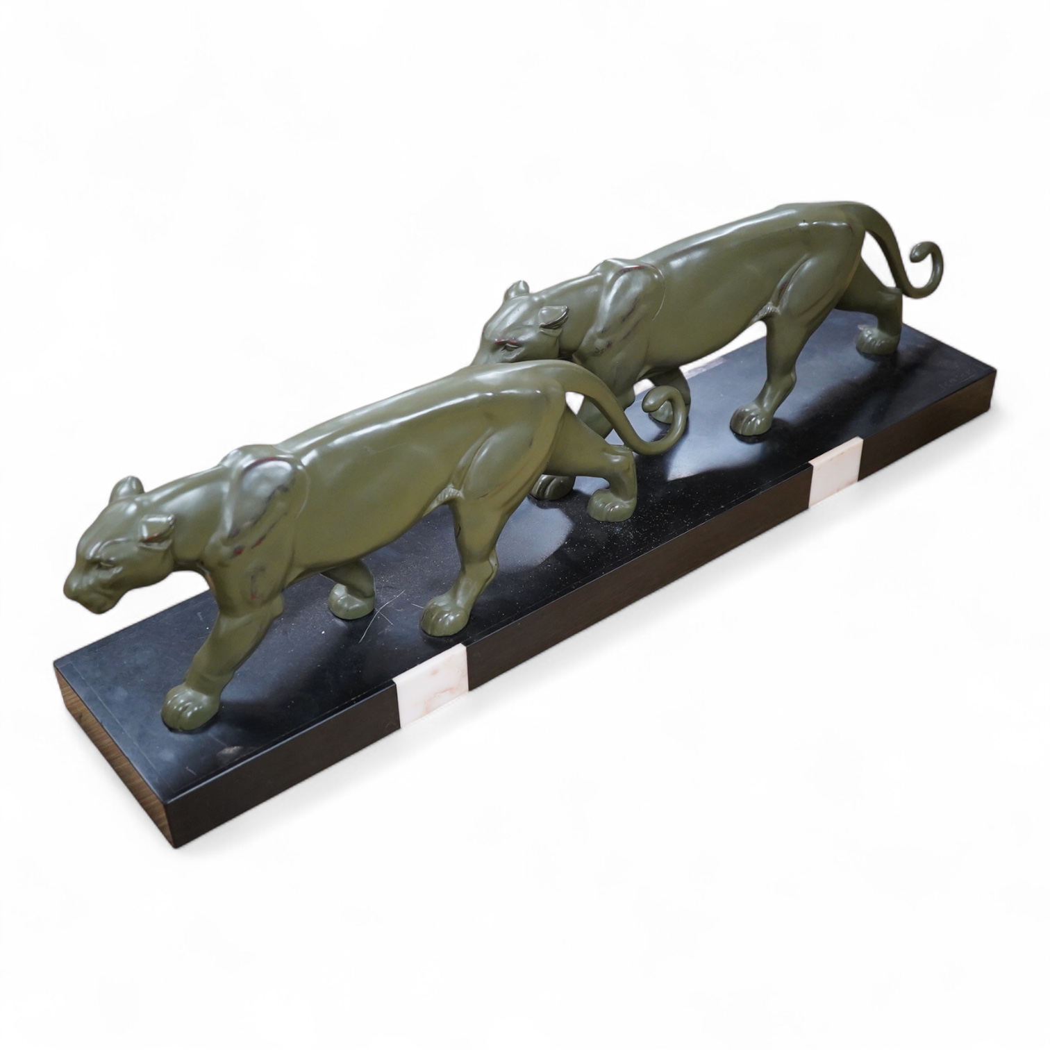 An Art Deco patinated spelter and marble figure of panthers, signed T. Cartier, 70cm